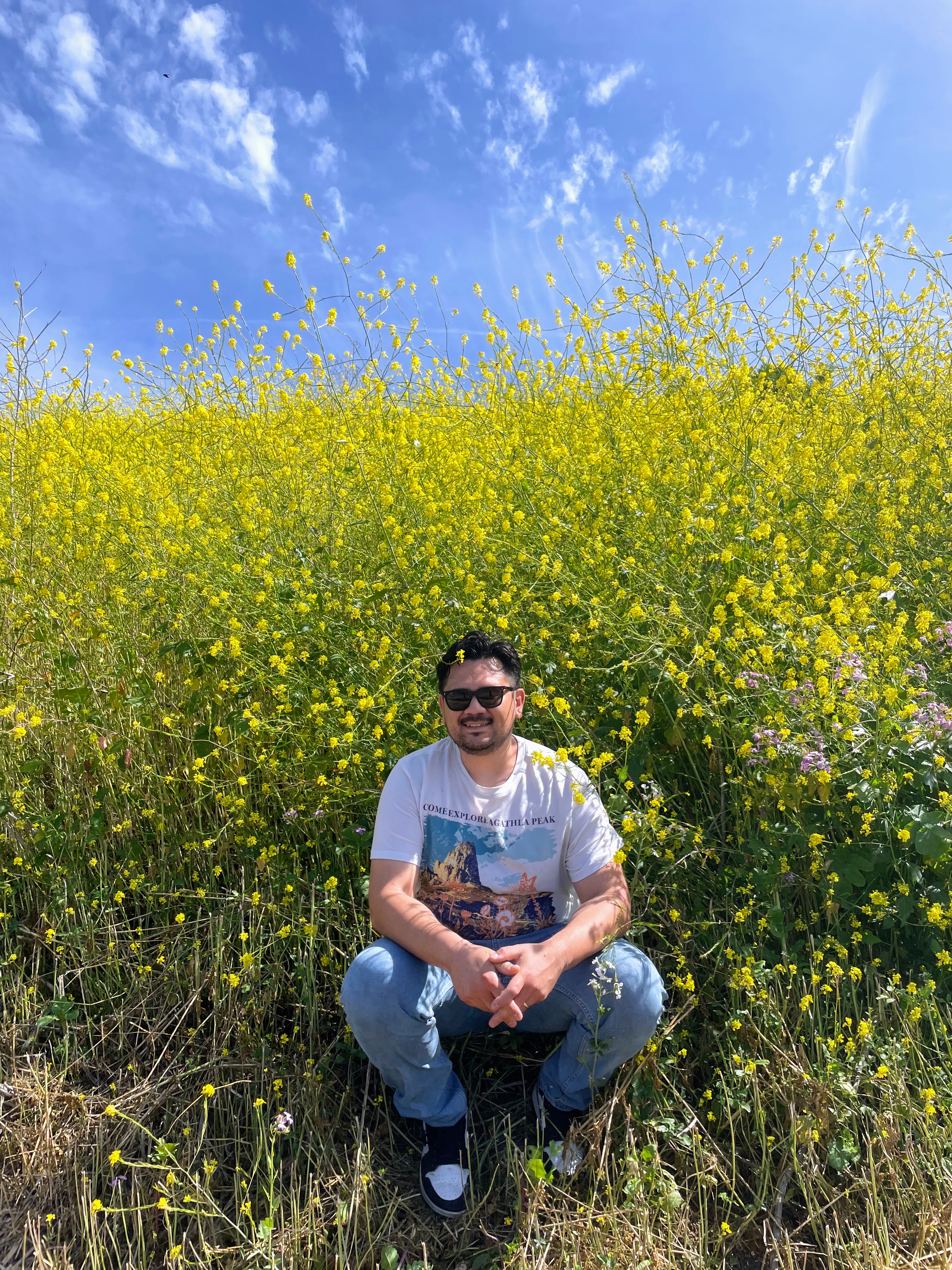 Cesar posing in a meadow of yellow flowers. 