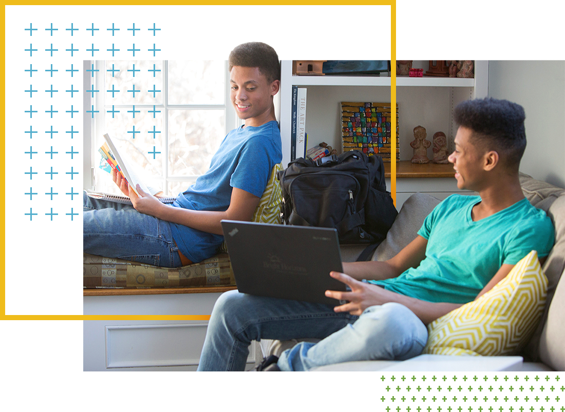 Two students looking at college apps on computer